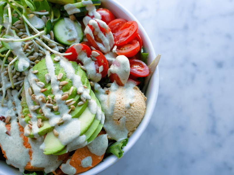 Salad topped with white dressing