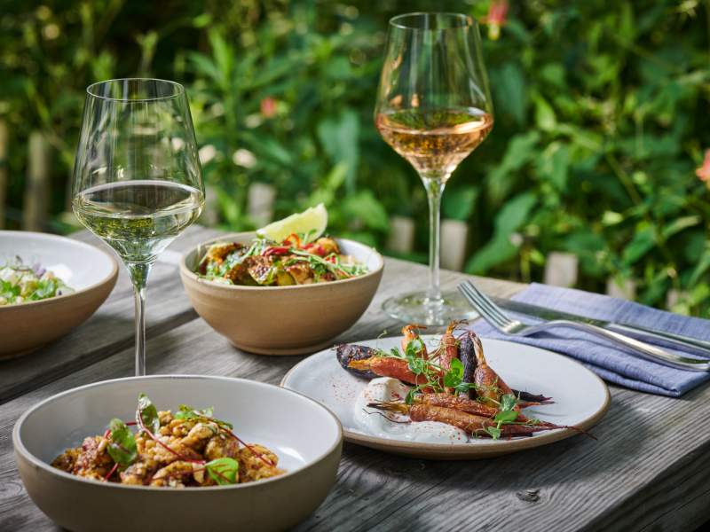 Table set with cutlery, drinks and food