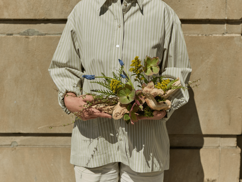 person with floral arrangement