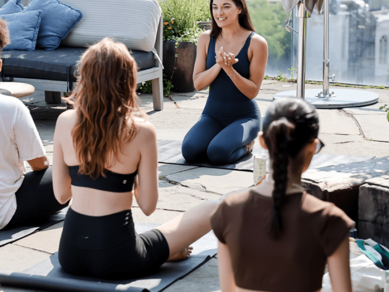 people doing yoga on rooftop