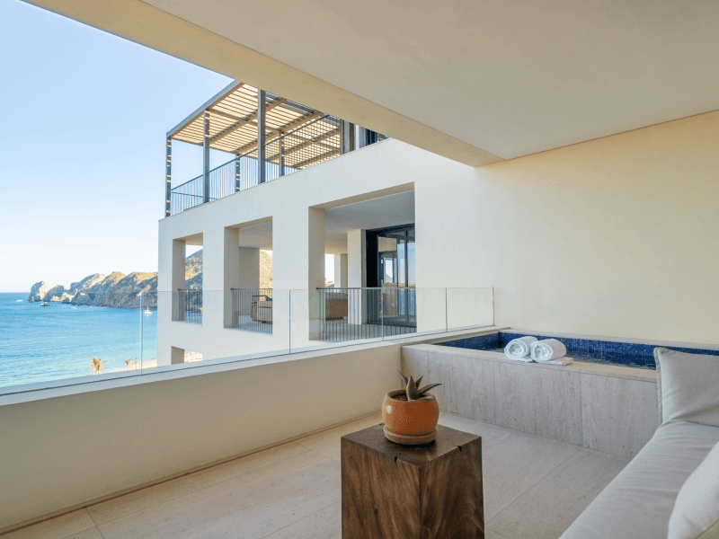 Covered outdoor patio with a personal pool and couch