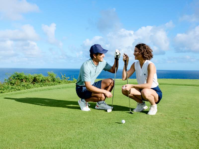 Two people enjoying their golf game. 