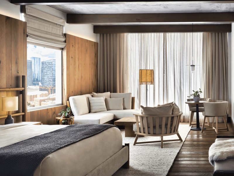 Dark toned bedroom with seating area in corner