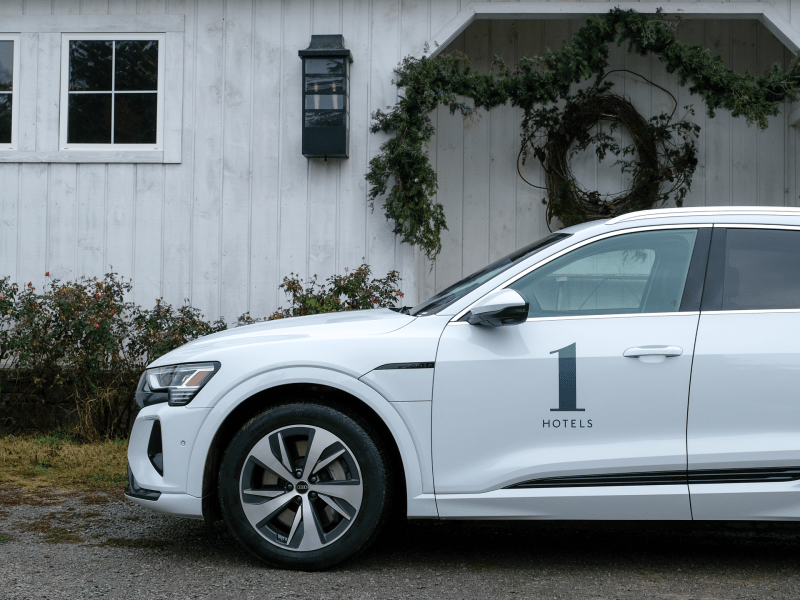 car next to barn