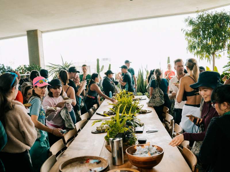 group of people sitting at a long table