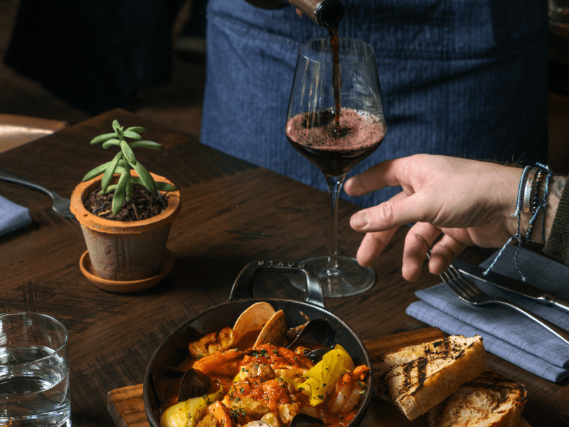 People being served wine during dinner