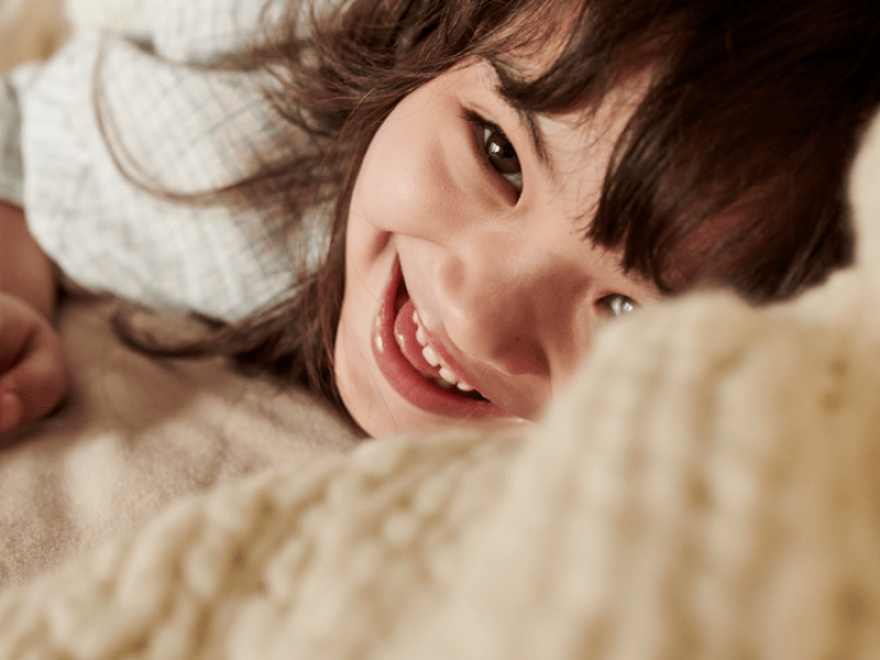 A child under a blanket