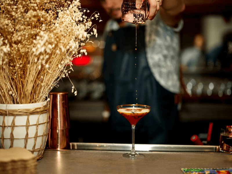 A bartender mixing a cocktail 