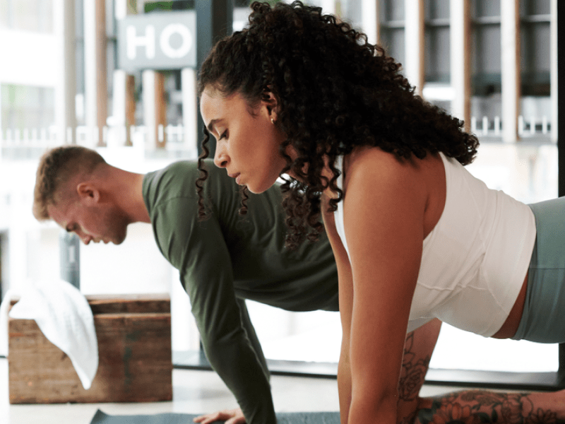 Two people working out on yoga mats