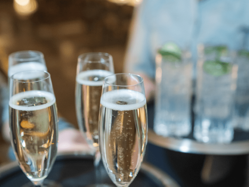 Server holding a tray of champagne 