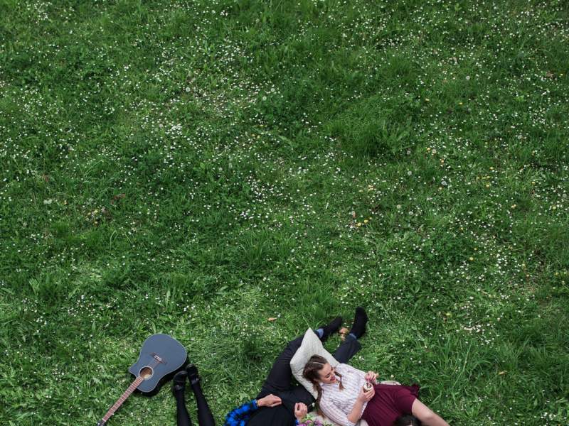 Group of people lying on the ground together at a picnic