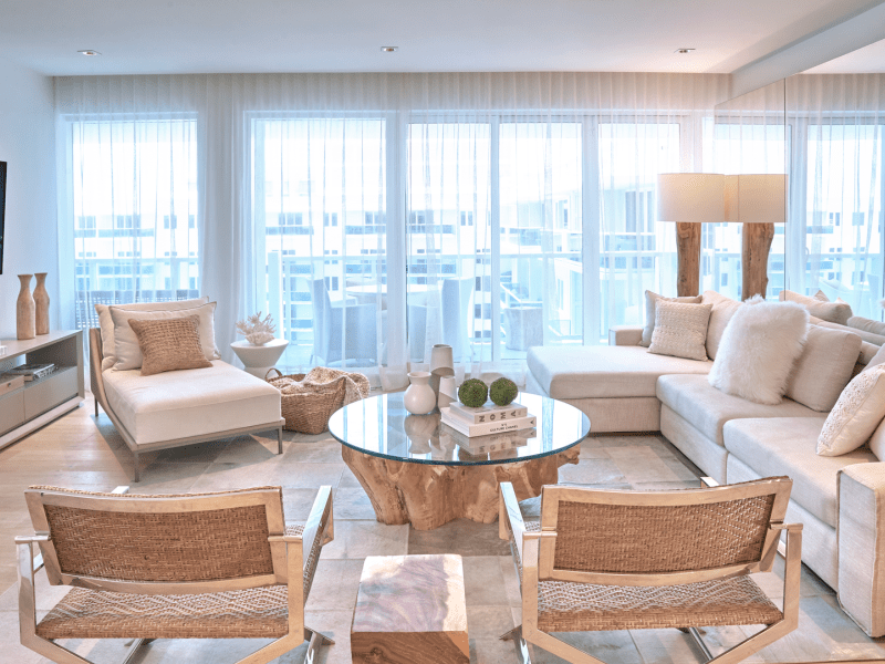 A living room with a sectional couch and chairs