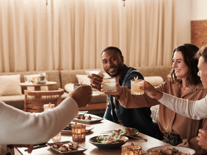 Group cheer-sing drinks at dinner 