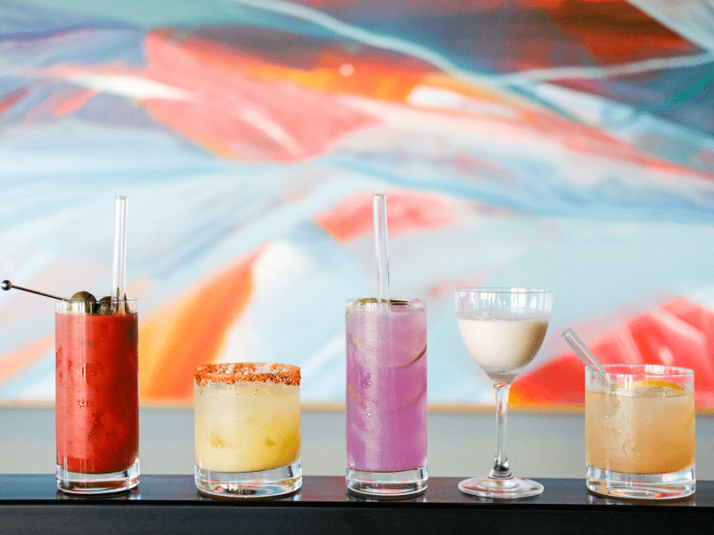 A variety of colorful cocktails aligned in a row