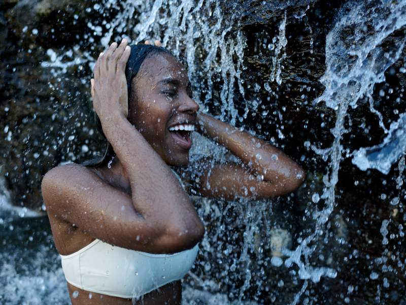 Model Enjoying a Waterfall on her Wellness Journey