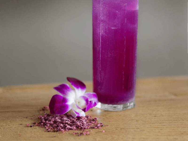 purple cocktail in tall glass