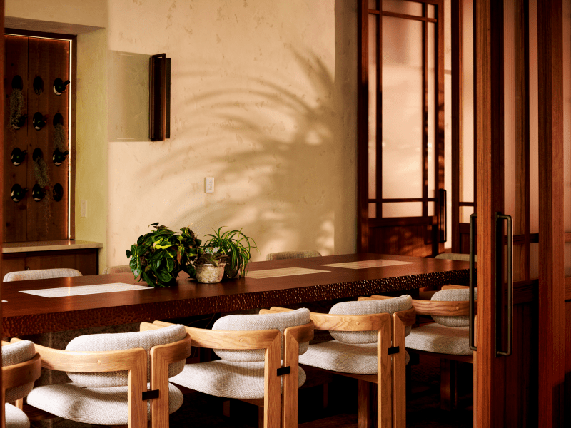 long stone table with wooden chairs