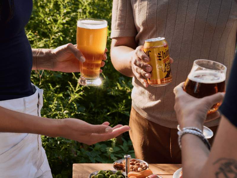 3 people holding beers in barbuto garden