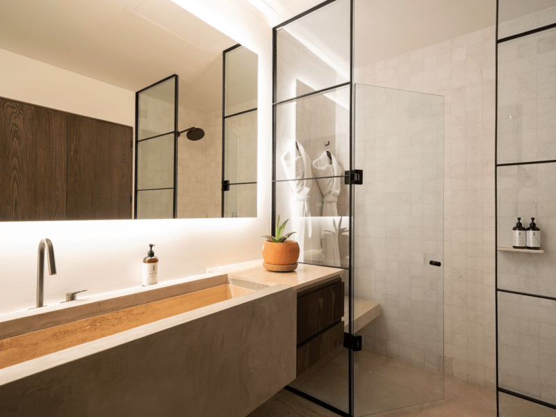 A wide bathroom sink next to a glass shower