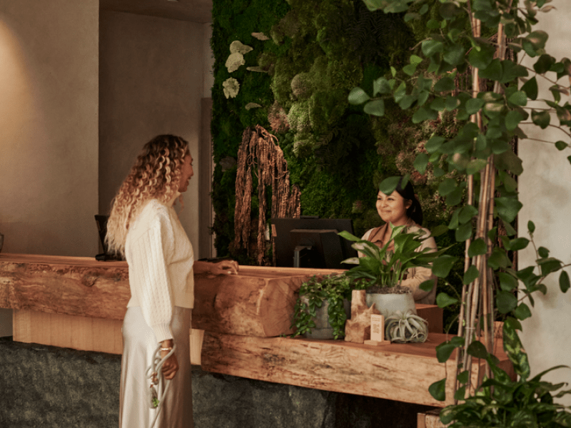 woman checking in at the front desk with her dog