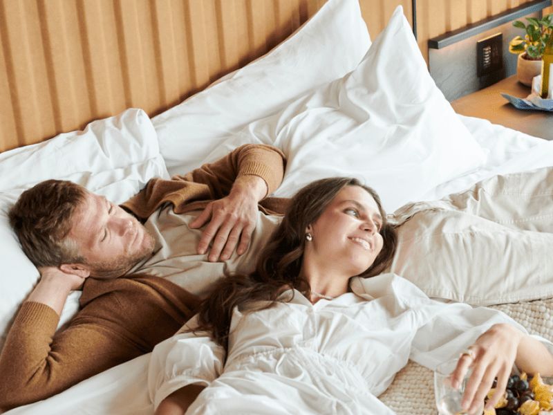 Two people relaxing in bed