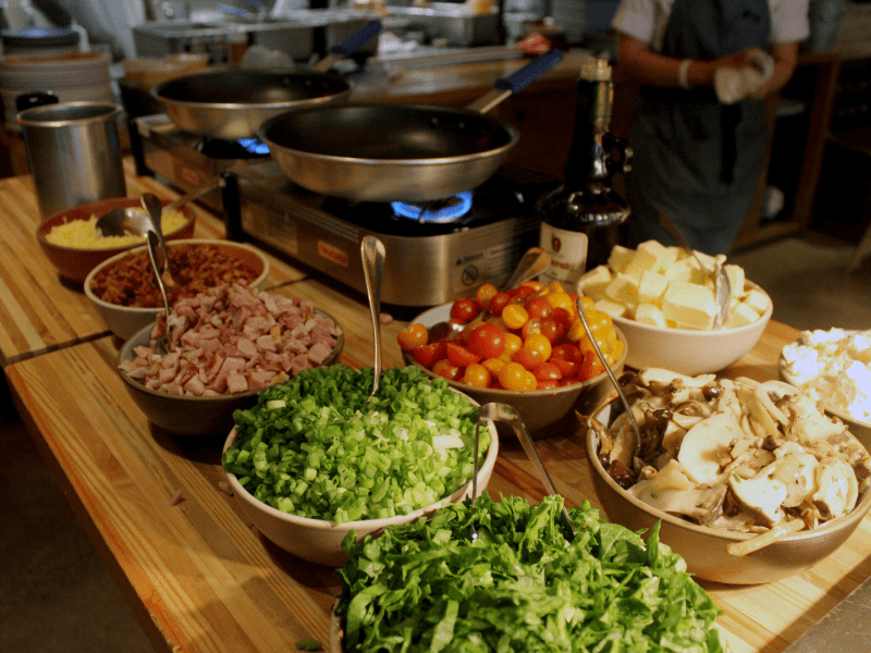 Platter of ingredients in front of a propane stove