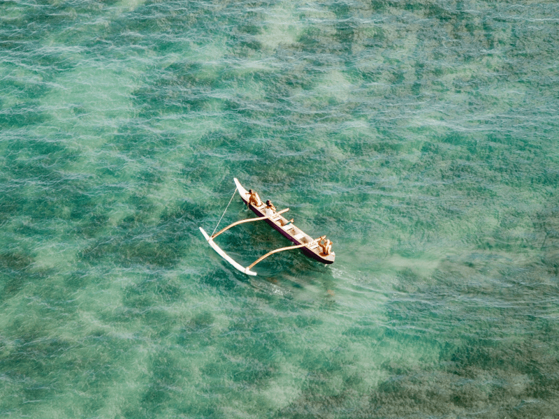 People on an outrigger on the water