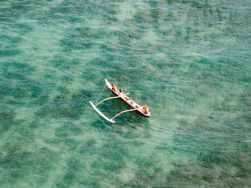 People on an outrigger on the water