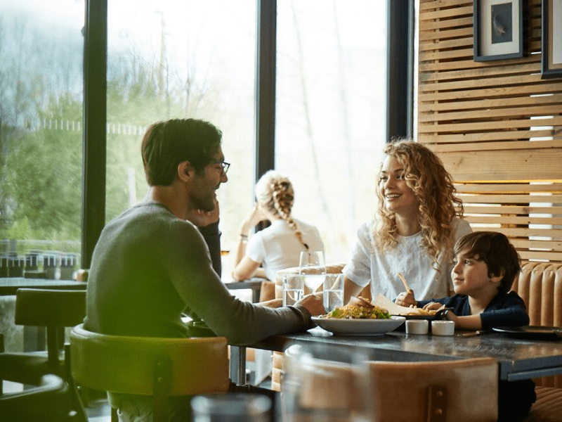 Family sitting at a table eating breakfast