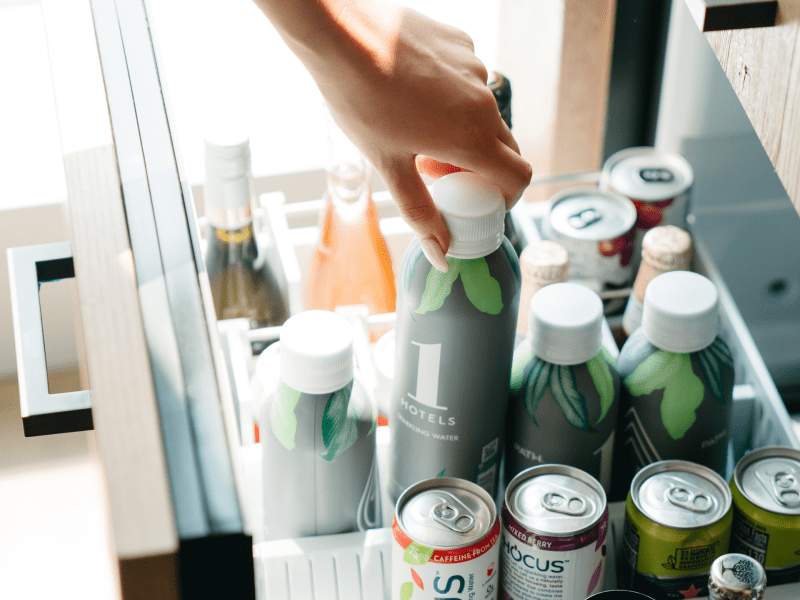 Person taking drink from minibar
