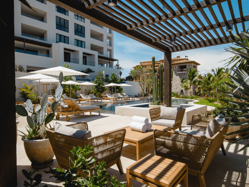 Covered seating area outside next to a pool