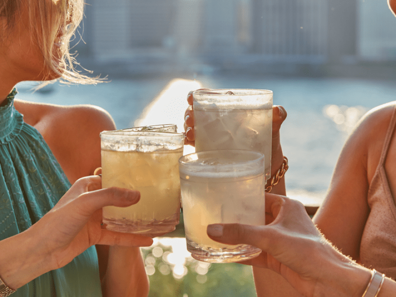 People raising glasses and cheering