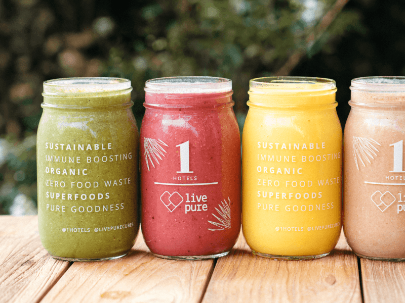 Four mason jars with smoothies lined up