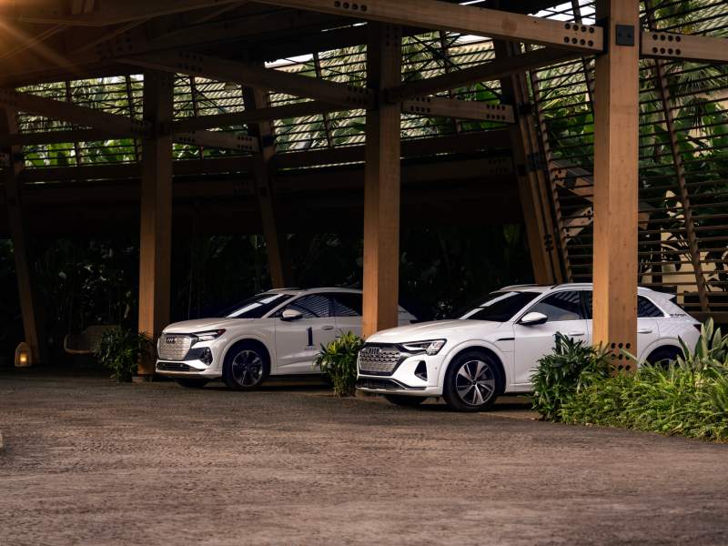 Two 1 Hotels Audi electric house cars in a parking garage.