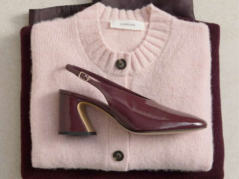 a stack of clothing and shoe in red hue