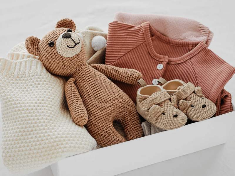 a box filled with baby clothes