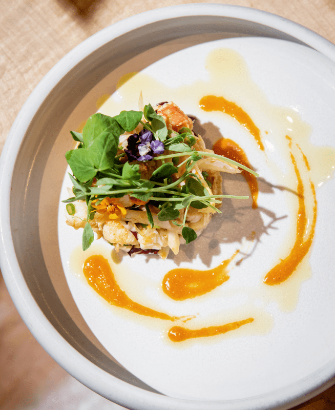 A plated dish with greens