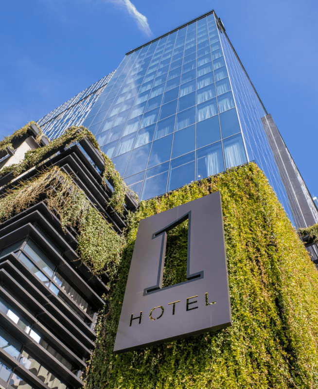 Looking up at 1 Hotel Nashville covered in plants