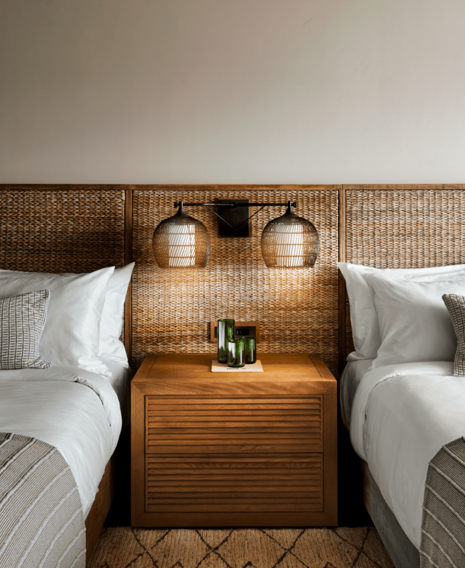 Two large beds with wicker headboards side by side