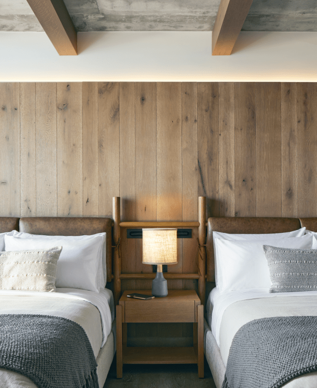 Two double beds with wooden headboards sit side by side