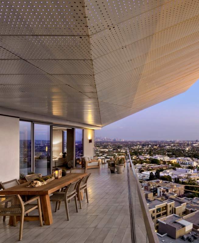 A high up balcony with a table and chairs