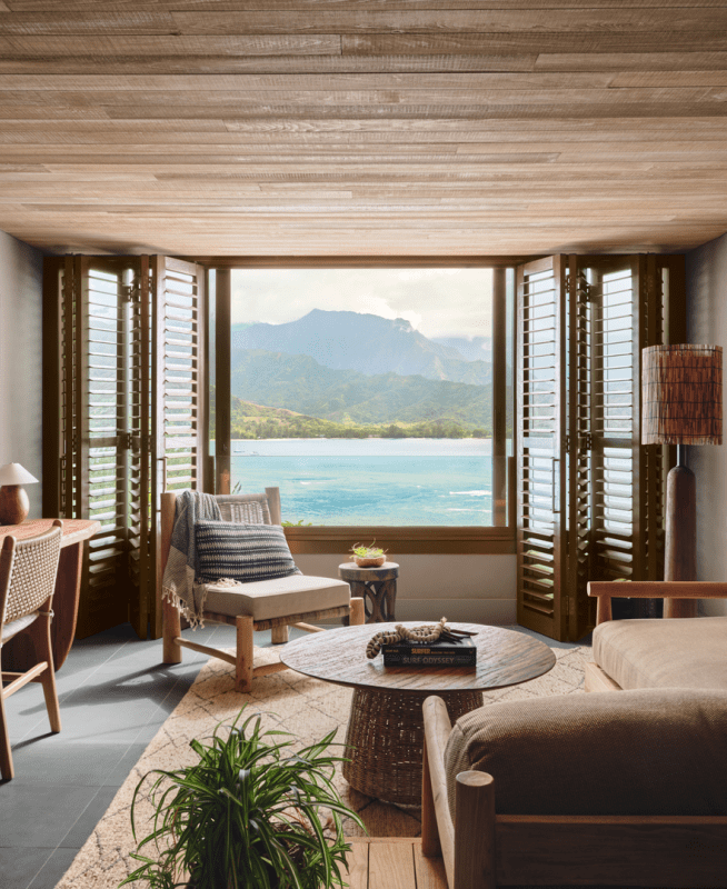 Living area with a deep sectional couch and a window looking out to the water