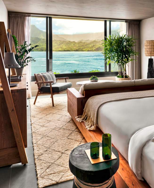 A bedroom with a view of the ocean just outside