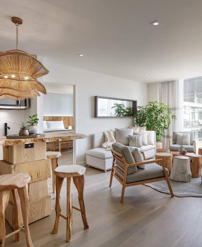 A 1 Hotels suite with full kitchenette, living room area, and bedroom