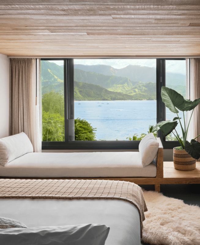 A hotel room with a view of the ocean just outside