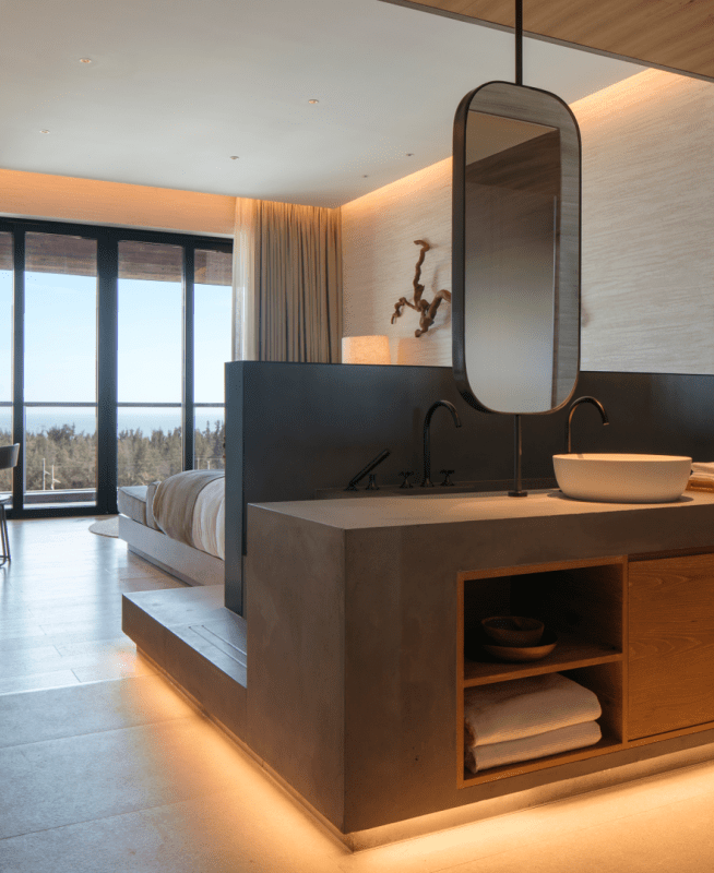 Hotel room with double sinks and a view out to the ocean