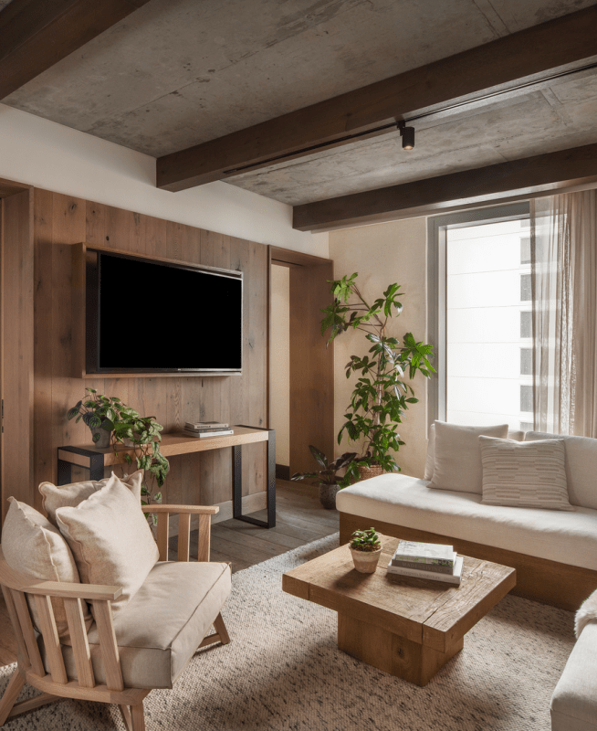 Wood paneled living room with a sectional couch