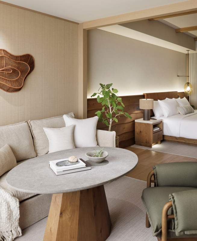 Warm-toned large room with bed, couch, and bathroom