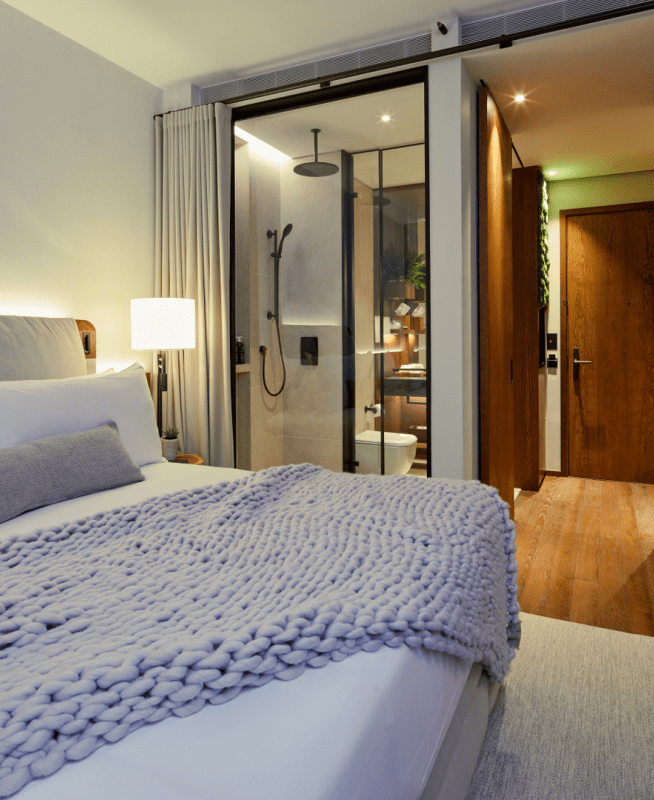 Bed with a blanket laid across it