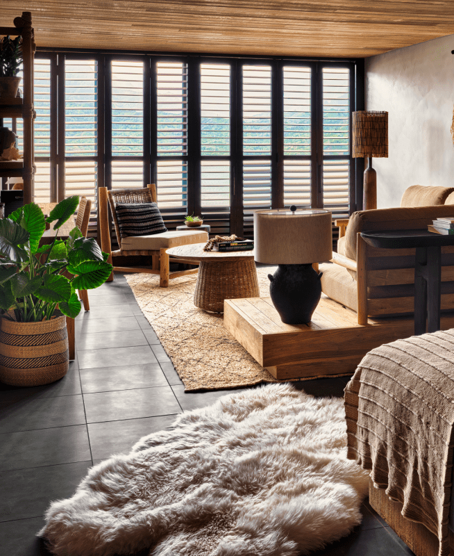 Bedroom with king size bed overlooks a spacious living area 